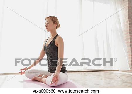 Attractive young Japanese practicing yoga in an airy room View Large Photo Image Stock Image - Attractive young Japanese practicing yoga in an airy room. Fotosearch
