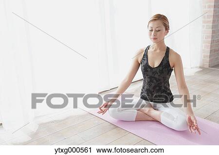 Attractive young Japanese practicing yoga in an airy room View Large Photo Image Stock Image - Attractive young Japanese practicing yoga in an airy room. Fotosearch