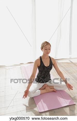 Attractive young Japanese practicing yoga in an airy room View Large Photo Image Stock Image - Attractive young Japanese practicing yoga in an airy room. Fotosearch
