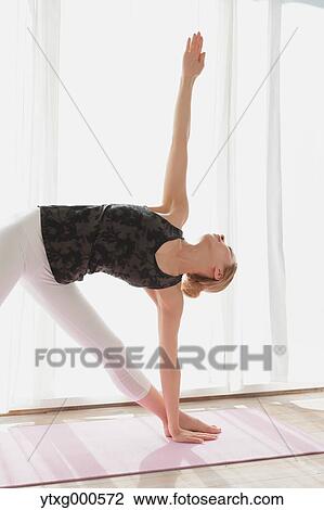 Attractive young Japanese practicing yoga in an airy room View Large Photo Image Stock Image - Attractive young Japanese practicing yoga in an airy room. Fotosearch