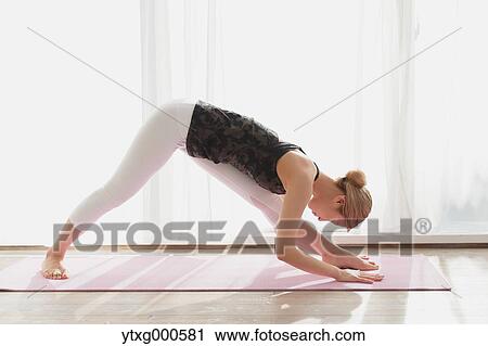 Attractive young Japanese practicing yoga in an airy room View Large Photo Image Stock Image - Attractive young Japanese practicing yoga in an airy room. Fotosearch