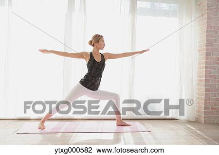 Attractive young Japanese practicing yoga in an airy room View Large Photo Image Stock Image - Attractive young Japanese practicing yoga in an airy room. Fotosearch