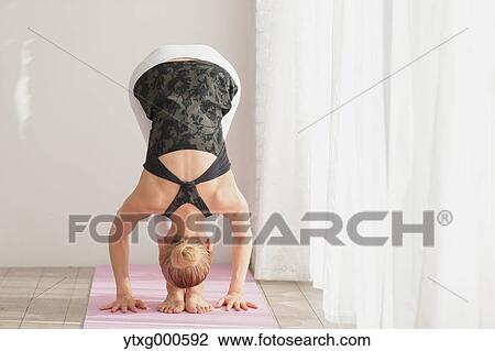 Attractive young Japanese practicing yoga in an airy room View Large Photo Image Stock Image - Attractive young Japanese practicing yoga in an airy room. Fotosearch
