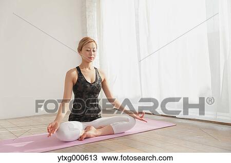 Attractive young Japanese practicing yoga in an airy room View Large Photo Image Stock Image - Attractive young Japanese practicing yoga in an airy room. Fotosearch