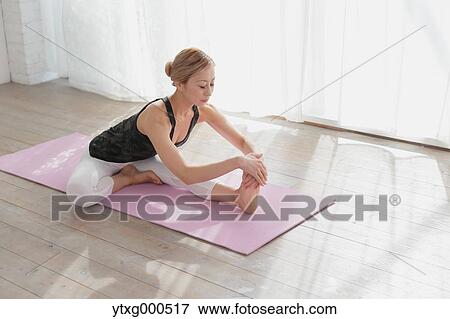 Attractive young Japanese practicing yoga in an airy room View Large Photo Image Stock Photo - Attractive young Japanese practicing yoga in an airy room. Fotosearch