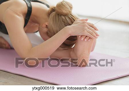 Attractive young Japanese practicing yoga in an airy room View Large Photo Image Stock Photo - Attractive young Japanese practicing yoga in an airy room. Fotosearch