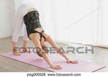 Attractive young Japanese practicing yoga in an airy room View Large Photo Image Stock Photo - Attractive young Japanese practicing yoga in an airy room. Fotosearch