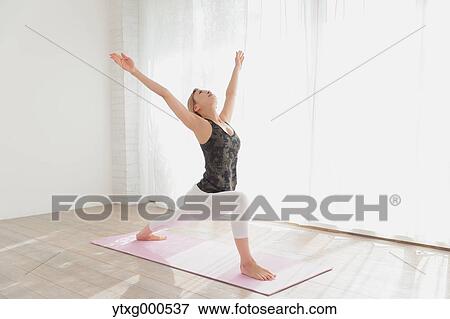 Attractive young Japanese practicing yoga in an airy room View Large Photo Image Stock Photo - Attractive young Japanese practicing yoga in an airy room. Fotosearch