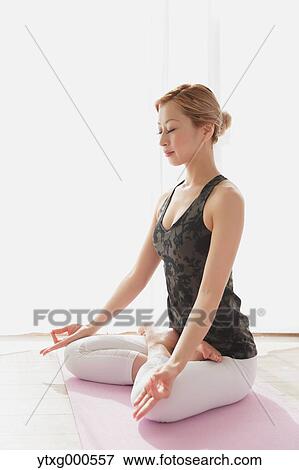 Attractive young Japanese practicing yoga in an airy room View Large Photo Image Stock Photo - Attractive young Japanese practicing yoga in an airy room. Fotosearch