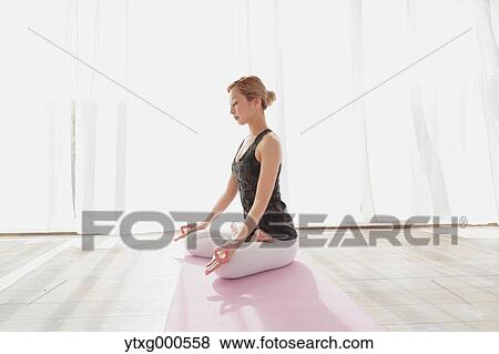 Attractive young Japanese practicing yoga in an airy room View Large Photo Image Stock Photo - Attractive young Japanese practicing yoga in an airy room. Fotosearch