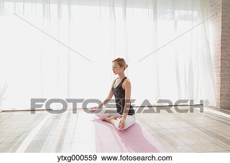 Attractive young Japanese practicing yoga in an airy room View Large Photo Image Stock Photo - Attractive young Japanese practicing yoga in an airy room. Fotosearch