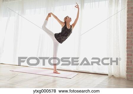 Attractive young Japanese practicing yoga in an airy room View Large Photo Image Stock Photo - Attractive young Japanese practicing yoga in an airy room. Fotosearch