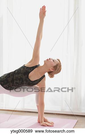 Attractive young Japanese practicing yoga in an airy room View Large Photo Image Stock Photo - Attractive young Japanese practicing yoga in an airy room. Fotosearch