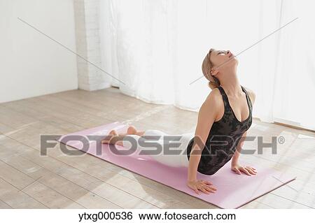 Attractive young Japanese practicing yoga in an airy room View Large Photo Image Stock Photograph - Attractive young Japanese practicing yoga in an airy room. Fotosearch