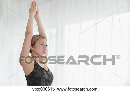 Attractive young Japanese practicing yoga in an airy room View Large Photo Image Stock Photography - Attractive young Japanese practicing yoga in an airy room. Fotosearch