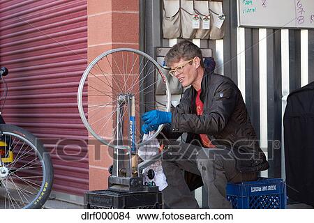 Bicycle taxi driver fixing his vehicle, Salt Like City, USA View Large Photo Image Picture - Bicycle taxi driver fixing his vehicle, Salt Like City, USA. Fotosearch