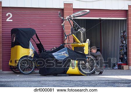 Bicycle taxi driver fixing his vehicle, Salt Like City, USA View Large Photo Image Stock Image - Bicycle taxi driver fixing his vehicle, Salt Like City, USA. Fotosearch