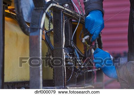 Bicycle taxi driver fixing his vehicle, Salt Like City, USA View Large Photo Image Stock Photo - Bicycle taxi driver fixing his vehicle, Salt Like City, USA. Fotosearch