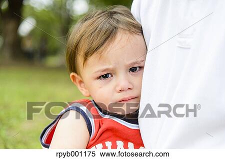 Crying kid on dad's shoulder View Large Photo Image Stock Photography - Crying kid on dad's shoulder. Fotosearch