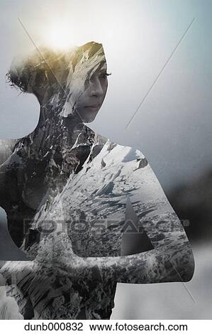 Stock Image - Double exposure of Asian woman practicing yoga and snowy mountainscape. Fotosearch