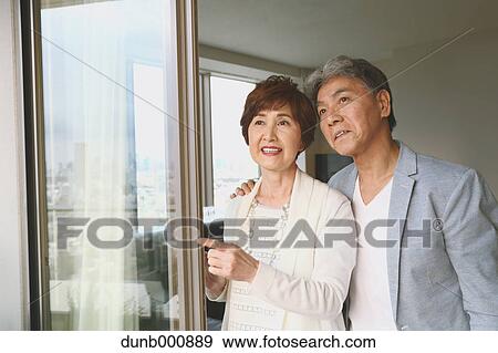 Fashionable Japanese senior couple by the window View Large Photo Image Stock Photo - Fashionable Japanese senior couple by the window. Fotosearch