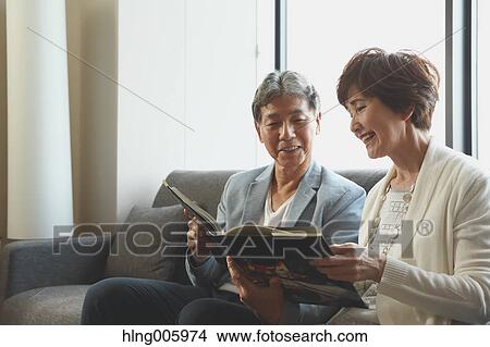 Fashionable Japanese senior couple on the sofa View Large Photo Image Picture - Fashionable Japanese senior couple on the sofa. Fotosearch