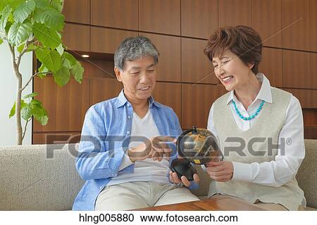 Fashionable Japanese senior couple on sofa View Large Photo Image Stock Image - Fashionable Japanese senior couple on sofa. Fotosearch
