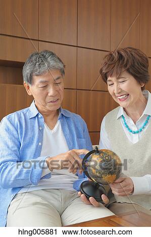 Fashionable Japanese senior couple on sofa View Large Photo Image Stock Image - Fashionable Japanese senior couple on sofa. Fotosearch