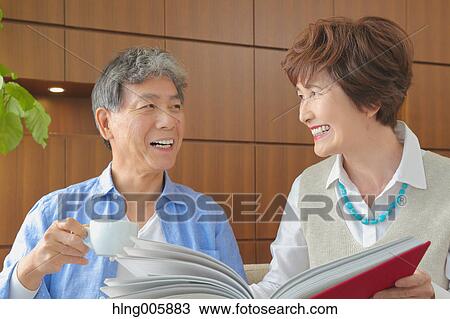 Fashionable Japanese senior couple on sofa View Large Photo Image Stock Image - Fashionable Japanese senior couple on sofa. Fotosearch