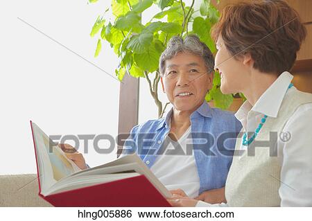 Fashionable Japanese senior couple on sofa View Large Photo Image Stock Photograph - Fashionable Japanese senior couple on sofa. Fotosearch