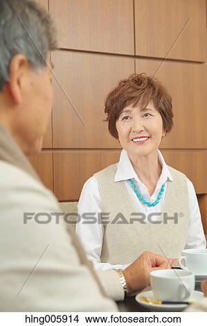 Fashionable Japanese senior couple enjoying a cup of coffee View Large Photo Image Picture - Fashionable Japanese senior couple enjoying a cup of coffee. Fotosearch