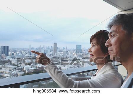 Fashionable Japanese senior couple enjoying Tokyo cityscape View Large Photo Image Picture - Fashionable Japanese senior couple enjoying Tokyo cityscape. Fotosearch