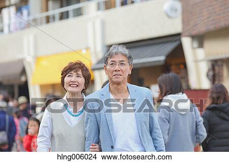 Fashionable Japanese senior couple walking downtown Tokyo View Large Photo Image Picture - Fashionable Japanese senior couple walking downtown Tokyo. Fotosearch