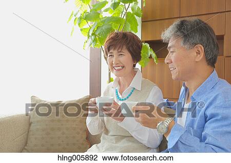 Fashionable Japanese senior couple enjoying a cup of coffee View Large Photo Image Stock Image - Fashionable Japanese senior couple enjoying a cup of coffee. Fotosearch