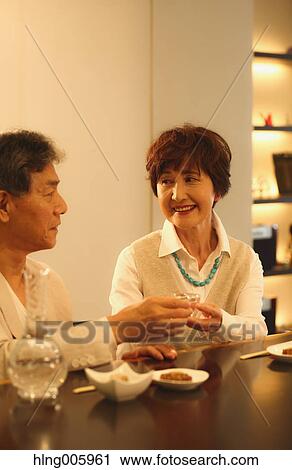 Fashionable Japanese senior couple having a good time at the restaurant View Large Photo Image Stock Image - Fashionable Japanese senior couple having a good time at the restaurant. Fotosearch