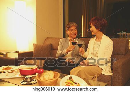 Fashionable Japanese senior couple toasting on sofa View Large Photo Image Stock Image - Fashionable Japanese senior couple toasting on sofa. Fotosearch