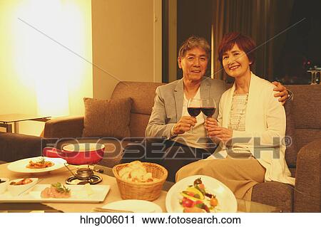 Fashionable Japanese senior couple toasting on sofa View Large Photo Image Stock Image - Fashionable Japanese senior couple toasting on sofa. Fotosearch