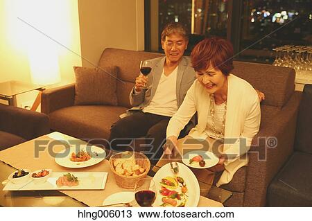 Fashionable Japanese senior couple toasting on sofa View Large Photo Image Stock Image - Fashionable Japanese senior couple toasting on sofa. Fotosearch