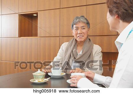 Fashionable Japanese senior couple enjoying a cup of coffee View Large Photo Image Stock Photo - Fashionable Japanese senior couple enjoying a cup of coffee. Fotosearch