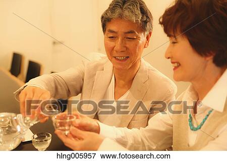 Fashionable Japanese senior couple having a good time at the restaurant View Large Photo Image Stock Photo - Fashionable Japanese senior couple having a good time at the restaurant. Fotosearch