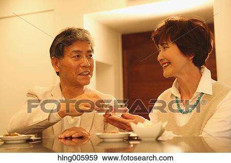 Fashionable Japanese senior couple having a good time at the restaurant View Large Photo Image Stock Photo - Fashionable Japanese senior couple having a good time at the restaurant. Fotosearch