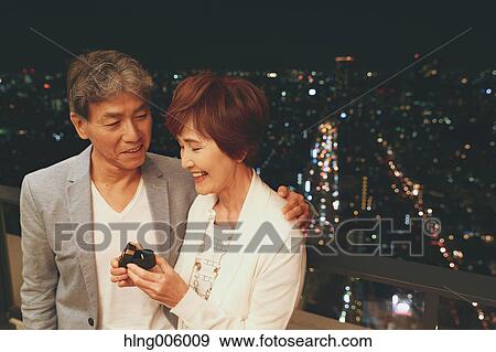 Fashionable Japanese senior couple celebrating with Tokyo cityscape in the background View Large Photo Image Stock Photo - Fashionable Japanese senior couple celebrating with Tokyo cityscape in the background. Fotosearch