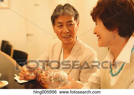 Fashionable Japanese senior couple having a good time at the restaurant View Large Photo Image Stock Photograph - Fashionable Japanese senior couple having a good time at the restaurant. Fotosearch