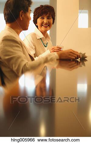 Fashionable Japanese senior couple having a good time at the restaurant View Large Photo Image Stock Photograph - Fashionable Japanese senior couple having a good time at the restaurant. Fotosearch