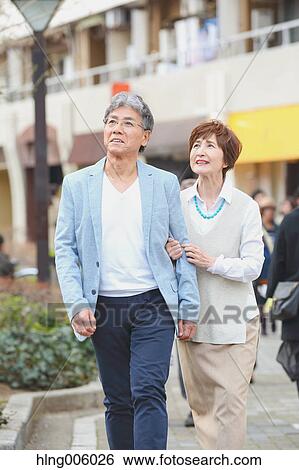 Fashionable Japanese senior couple walking downtown Tokyo View Large Photo Image Stock Photograph - Fashionable Japanese senior couple walking downtown Tokyo. Fotosearch