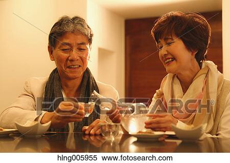 Fashionable Japanese senior couple having a good time at the restaurant View Large Photo Image Stock Photography - Fashionable Japanese senior couple having a good time at the restaurant. Fotosearch