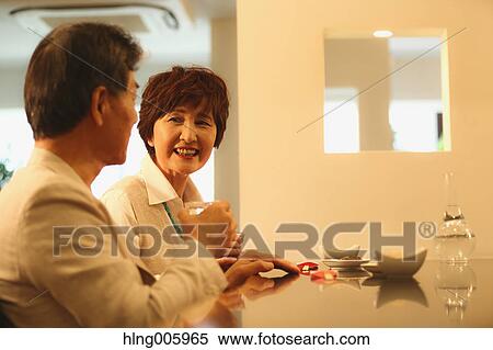 Fashionable Japanese senior couple having a good time at the restaurant View Large Photo Image Stock Photography - Fashionable Japanese senior couple having a good time at the restaurant. Fotosearch