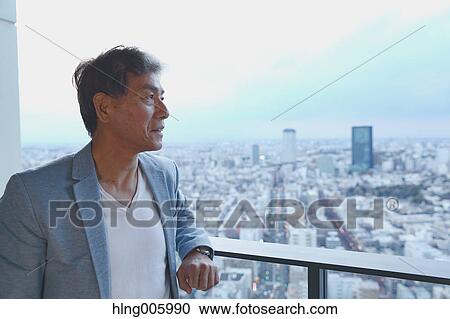 Fashionable Japanese senior man looking at Tokyo cityscape View Large Photo Image Stock Image - Fashionable Japanese senior man looking at Tokyo cityscape. Fotosearch