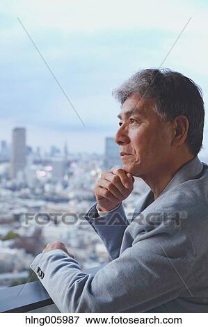 Fashionable Japanese senior man looking at Tokyo cityscape View Large Photo Image Stock Photo - Fashionable Japanese senior man looking at Tokyo cityscape. Fotosearch
