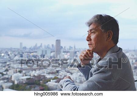 Fashionable Japanese senior man looking at Tokyo cityscape View Large Photo Image Stock Photograph - Fashionable Japanese senior man looking at Tokyo cityscape. Fotosearch